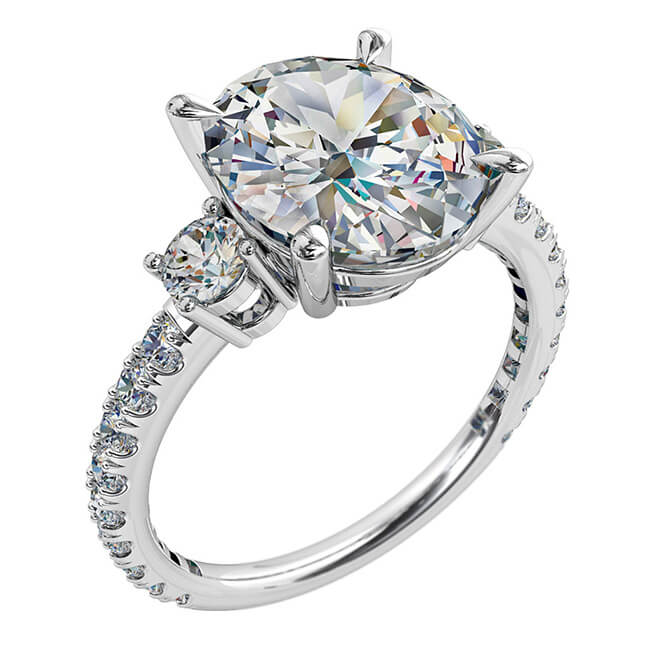 Oval Cut Trilogy Diamond Engagement Ring, with Round Side Stones on a Diamond Cut Claw Band.