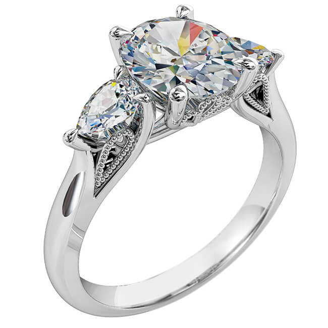 Oval Cut Trilogy Diamond Engagement Ring, with Pear Shape Side Stones and a Vintage Filigree Undersetting.